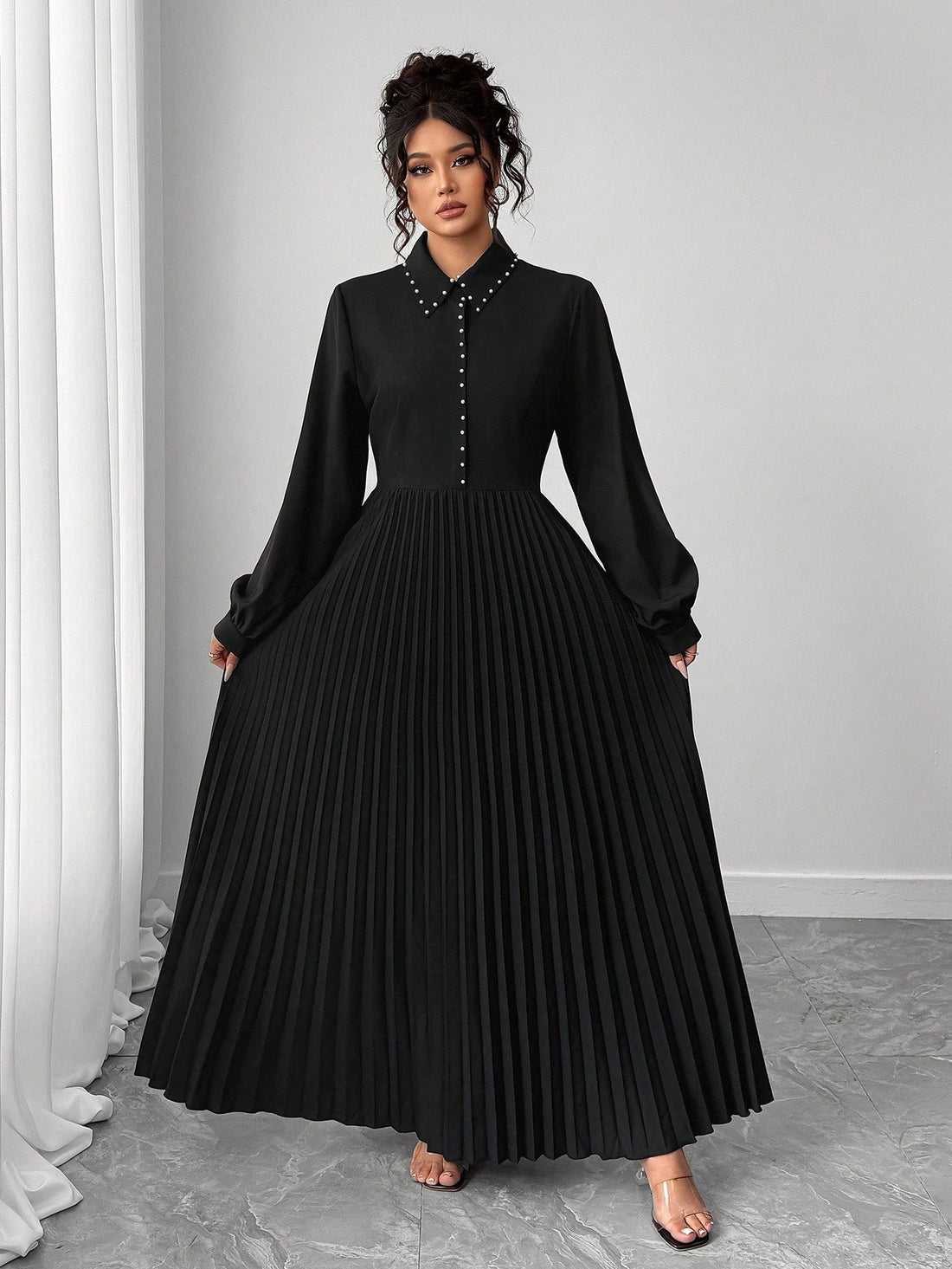 Elevate your fall wardrobe with this chic A-line pleated dress that strikes the perfect balance between polished and playful. The minimalist silhouette flatters every frame, while the studded contrast collar adds just the right amount of edge to keep things interesting. Whether you're heading to the office or weekend brunch, this versatile piece transitions seamlessly from workwear to after-hours style. The pleated design creates beautiful movement and dimension, making you feel confident and put-together a