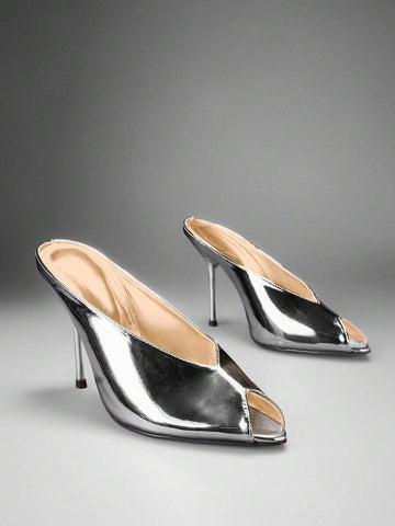 Silver front three-quarter product view of peep-toe stiletto mule sandals with a backless slip-on upper and slim high heel