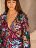 Turn heads at your next fall celebration in this stunning multicolour floral sequin mini dress. The plunging V-neckline and graceful flared sleeves create an effortlessly chic silhouette that's equal parts bold and elegant. Shimmering sequins catch the light with every move, while the vibrant floral pattern adds personality and flair. Perfect for parties, nights out, or any occasion where you want to feel absolutely fabulous. This dress is your ticket to standing out in the best way possible.