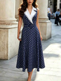 Front view of navy polka dot belted lapel midi dress with white notched collar