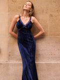 Slip into sophistication with this stunning navy blue velvet maxi dress, where luxe fabric meets modern flair. The delicate lace cut-outs add an unexpected twist of elegance, creating an eye-catching silhouette perfect for fall galas, winter weddings, and special occasions. Velvet's rich texture catches the light beautifully, while the maxi length offers graceful movement and timeless appeal. Whether you're dancing the night away or making a grand entrance, this dress delivers that perfect balance of refine