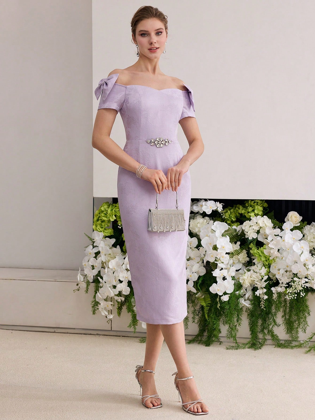 Step into the spotlight with this playful off-shoulder dress featuring a delicate floral jacquard pattern that adds texture and charm. The flirtatious bow accentuates your waist, while subtle rhinestone details bring just the right amount of sparkle for any occasion. Designed to turn heads and keep your style fun and elegant, this dress is perfect for making memorable moments even more delightful.