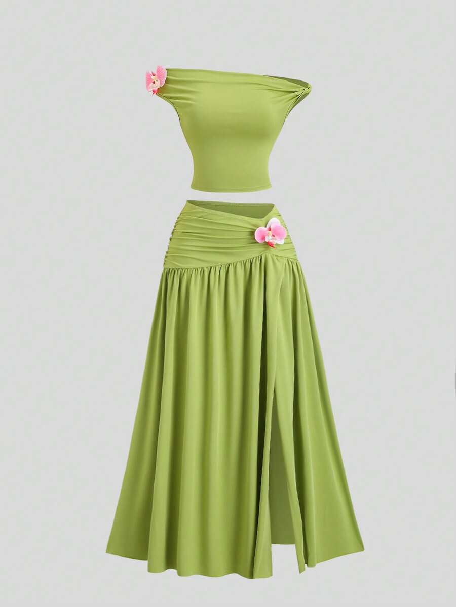 Front view of lime green bandeau crop top and long ruched skirt set with pink orchid appliques