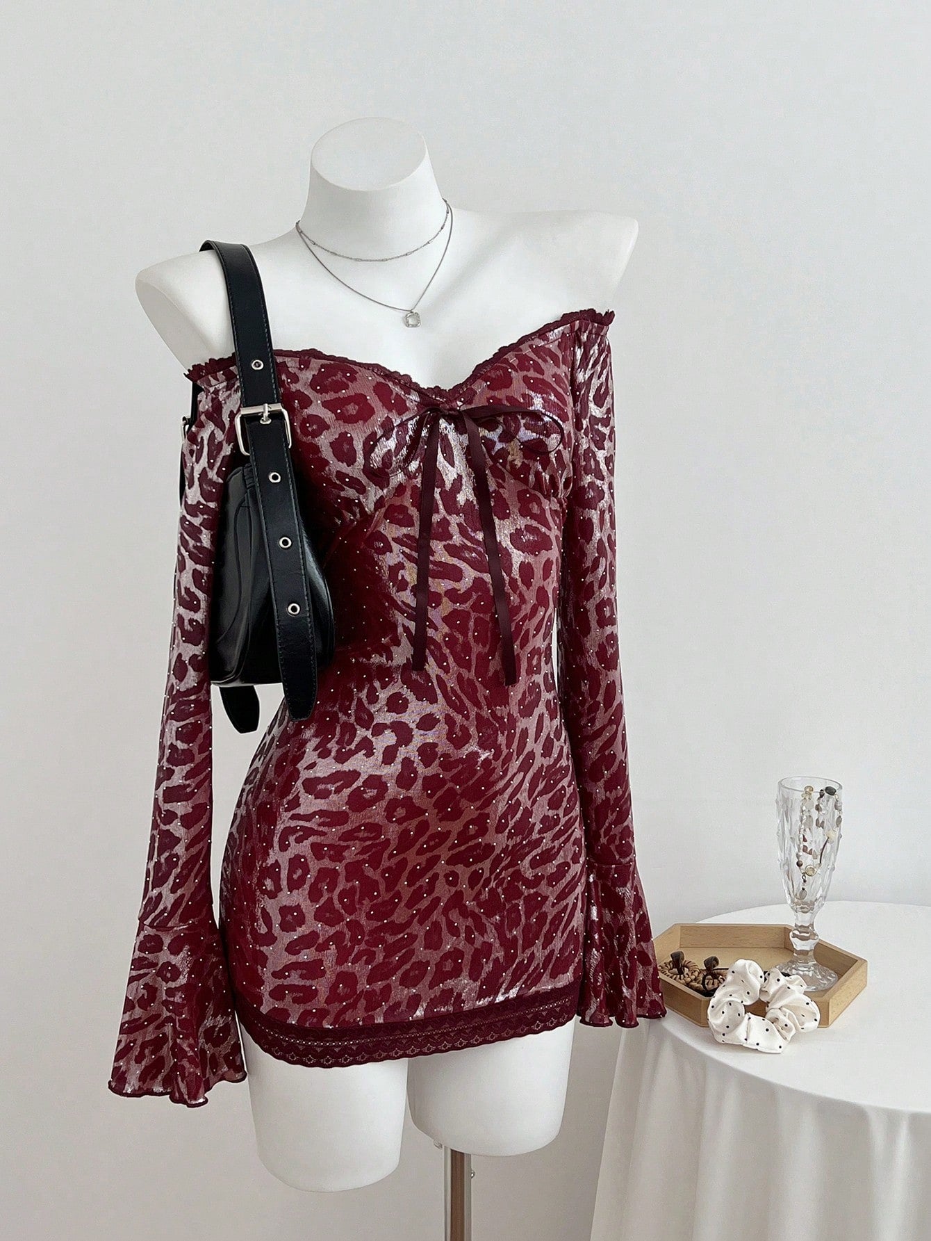 Turn heads at your next soirée in this show-stopping mini dress that perfectly blends wild and refined. The off-shoulder neckline frames your shoulders beautifully, while the leopard print adds a daring edge that's totally on-trend. Delicate lace patchwork and sparkling rhinestones elevate the look from casual to cocktail-ready in seconds. Whether you're hitting a party or making a grand entrance at an event, this dress delivers major style points without taking itself too seriously. It's the kind of piece 