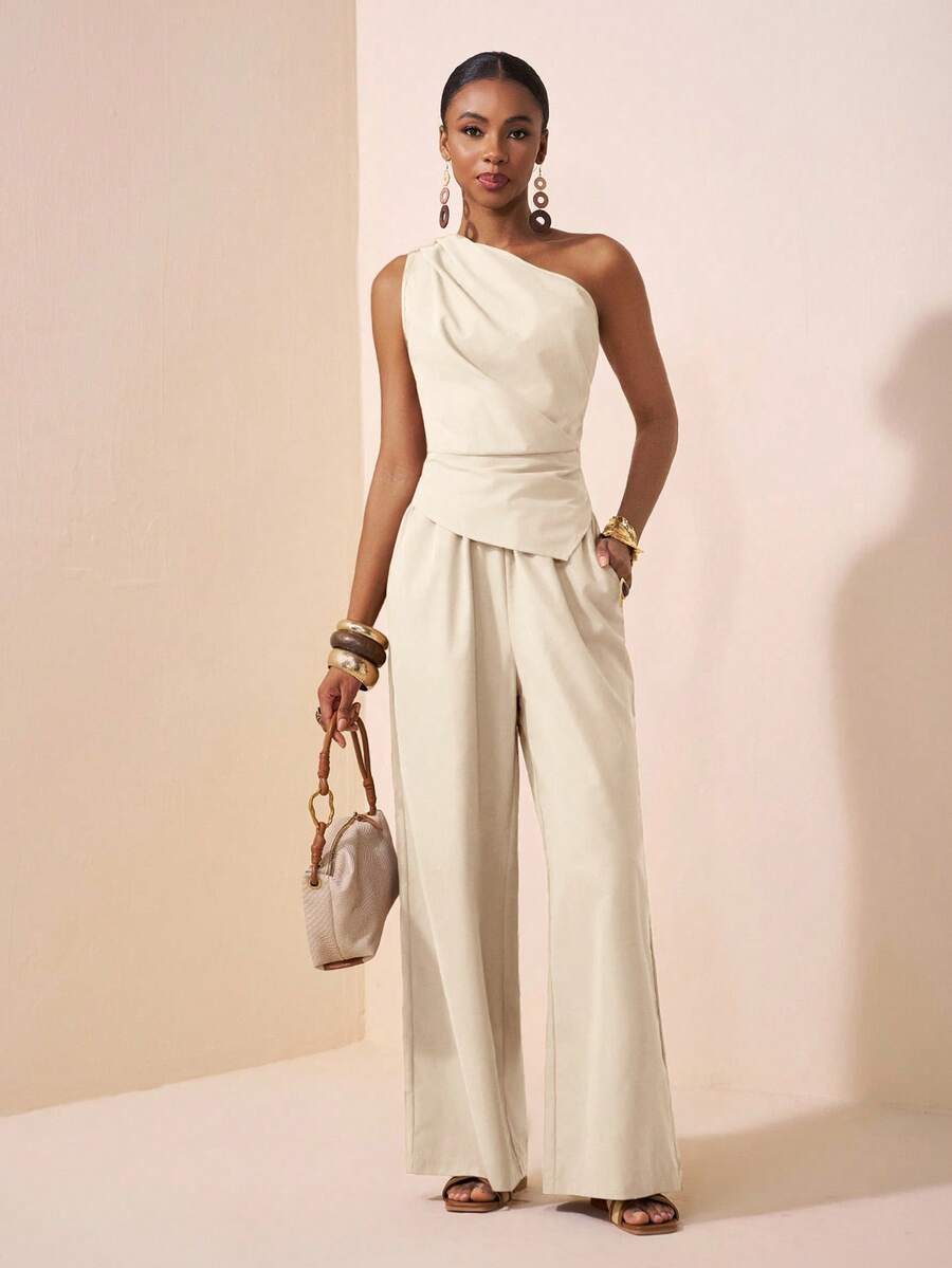 Elevate your festival wardrobe with this sophisticated one-shoulder khaki two-piece set. The asymmetrical neckline and sleeveless silhouette create an effortlessly elegant look, while the slim-fit design flatters your figure. Crafted from 100% polyester woven fabric, this set features a functional pocket and semi-sheer detailing for added dimension. Perfect for Eid celebrations, summer gatherings, and special occasions. 