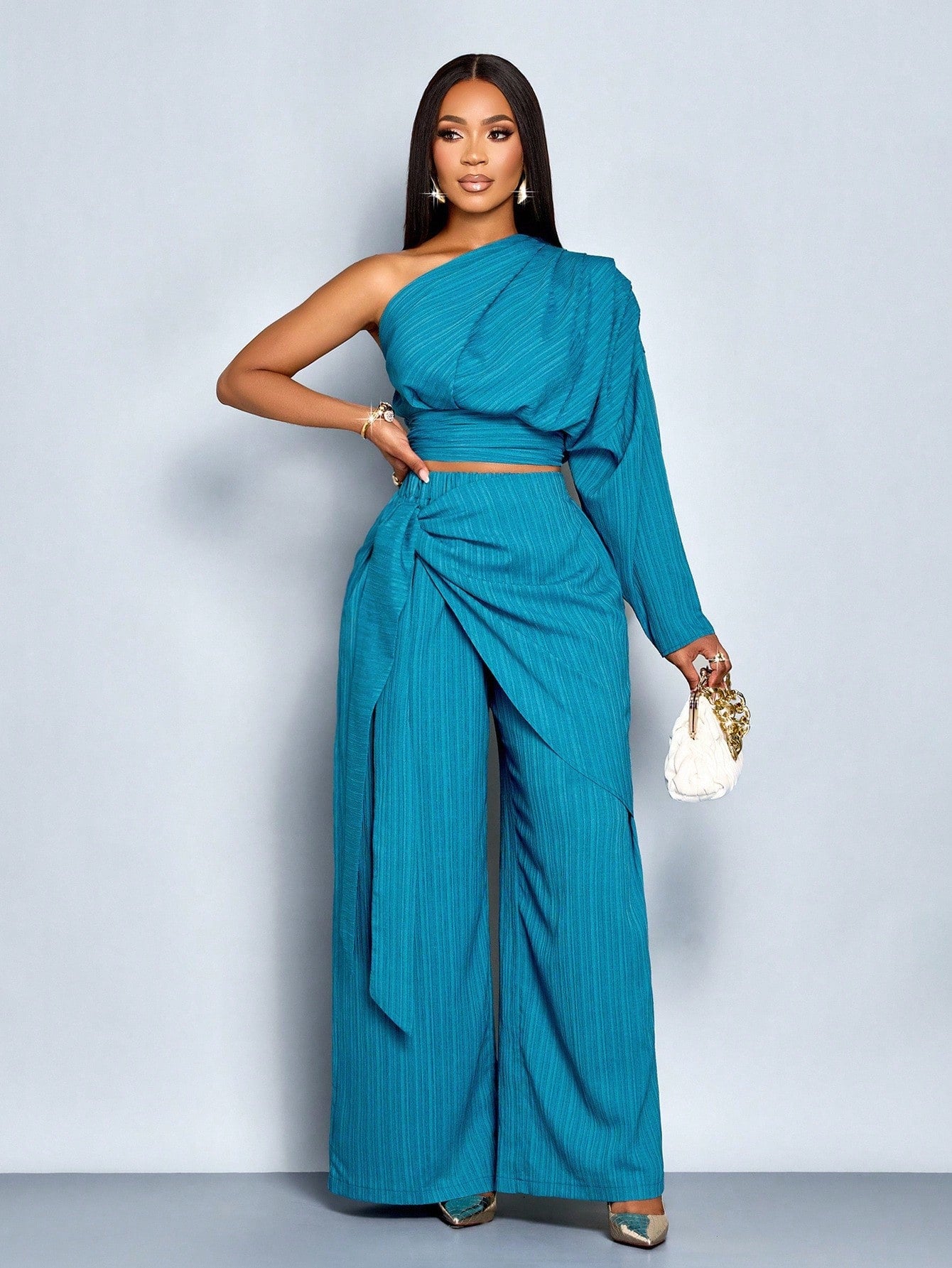Elevate your winter wardrobe with this show-stopping two-piece set that's basically a shortcut to looking effortlessly put-together. The one-shoulder pleated blouse brings drama and sophistication, while the belted high-waist wide-leg pants deliver that coveted polished silhouette. Whether you're heading to brunch, the office, or a night out, this dynamic duo works overtime to keep you looking chic without the fuss. Mix, match, or wear together—either way, you're winning the style game.