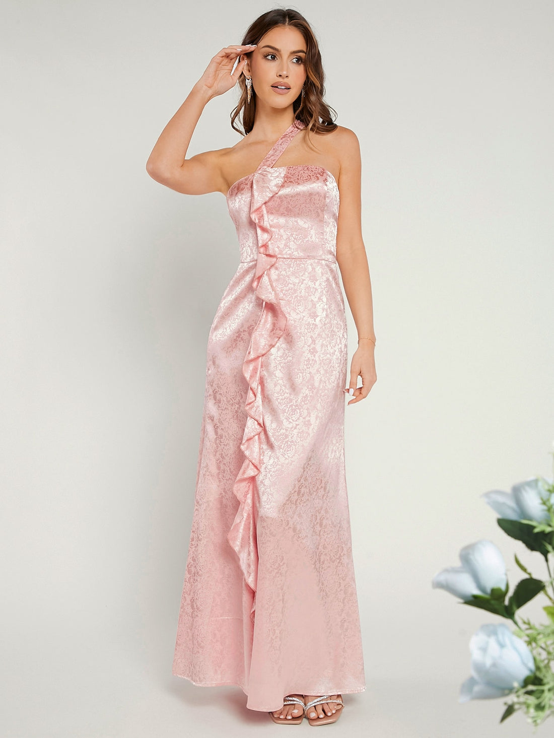Steal the spotlight in this stunning one-shoulder bridesmaid dress that's anything but ordinary! Featuring an eye-catching jacquard fabric with delicate ruffles, this gown brings just the right amount of drama and elegance to any celebration. The asymmetrical neckline creates a chic, modern silhouette that flatters every figure, while the luxurious texture adds depth and dimension. Whether you're walking down the aisle or dancing the night away, this dress promises to turn heads and make you feel absolutely