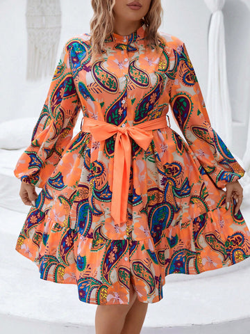 Stun in this elegant paisley print dress designed for plus sizes. Beautiful lantern sleeves and a ruffled hem add a touch of sophistication, while the belted waist accentuates your curves. Perfect for any formal occasion, this dress is sure to make you stand out.