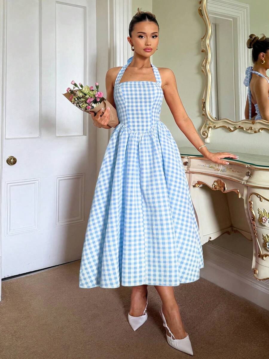Step into enchantment with this charming pastoral princess dress, where timeless elegance meets modern flair. The fitted bodice hugs your silhouette beautifully before flowing into a graceful swing skirt that twirls with every movement. Crafted in a classic plaid pattern, the halter neckline adds a touch of sophistication while keeping things breezy and comfortable for warm weather. Perfect for garden parties, summer celebrations, or any occasion calling for a dash of whimsy and romance. This dress transfor