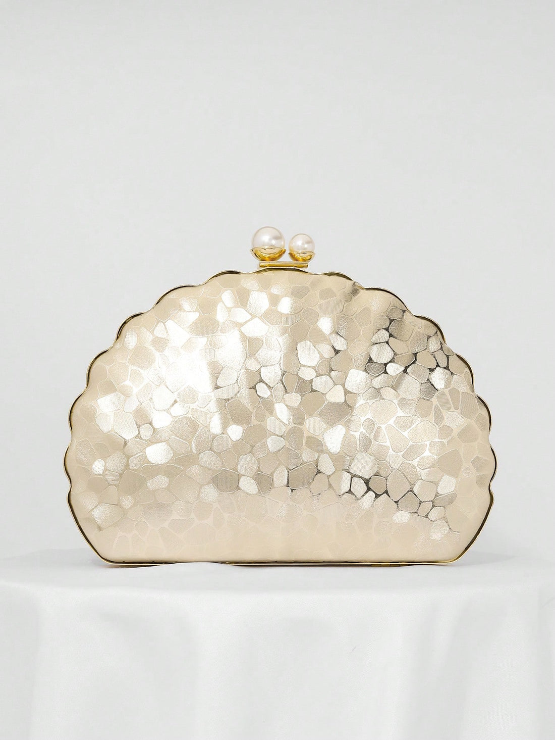 Add a touch of whimsy to your special night with this Elegant Pearl Shaped Clutch. Perfect for weddings and gala events, this stylish evening bag doubles as a charming bridal accessory. Its unique pearl shape brings a playful twist to classic elegance, making it the perfect companion to hold your essentials while turning heads wherever you go.