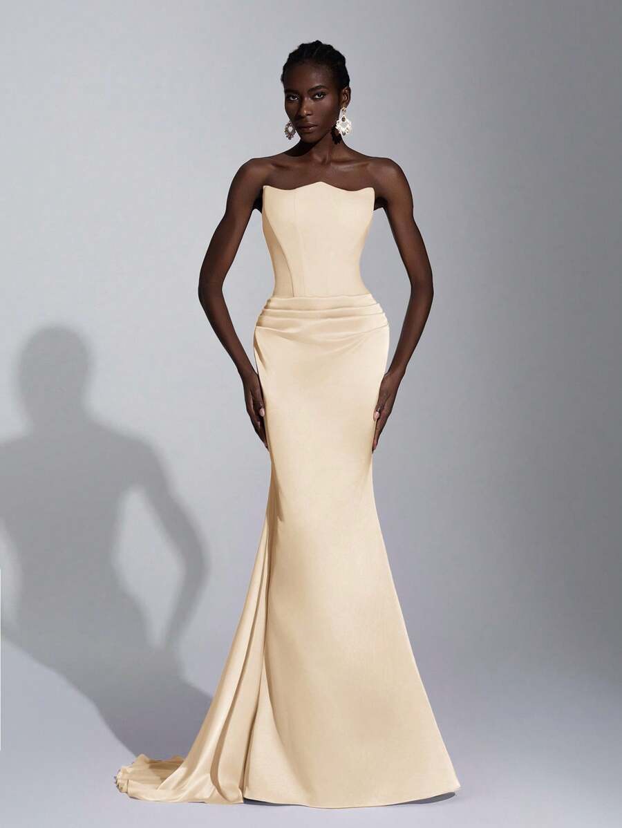 Make a statement in this stunning pink mermaid gown that's pure elegance with a playful twist. The asymmetrical strapless neckline creates an effortlessly chic silhouette, while the ruched waistline adds dimension and flatters your figure beautifully. Perfect for proms, galas, weddings, or any occasion where you want to turn heads and feel absolutely fabulous. This show-stopping dress combines sophisticated design with just enough drama to make you the star of the evening.