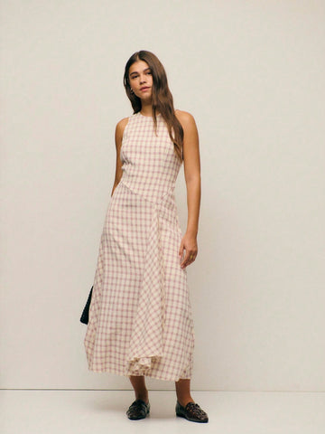 Step into effortless sophistication with this charming pink checked midi dress. The sleek sleeveless silhouette and high round neckline create a timeless, polished look that transitions seamlessly from brunch to evening plans. The classic gingham pattern adds a touch of vintage-inspired whimsy, while the midi length offers graceful coverage and flattering proportions. Perfect for anyone who loves a dress that's both put-together and playfully chic—pair it with your favorite sneakers for casual vibes or dres
