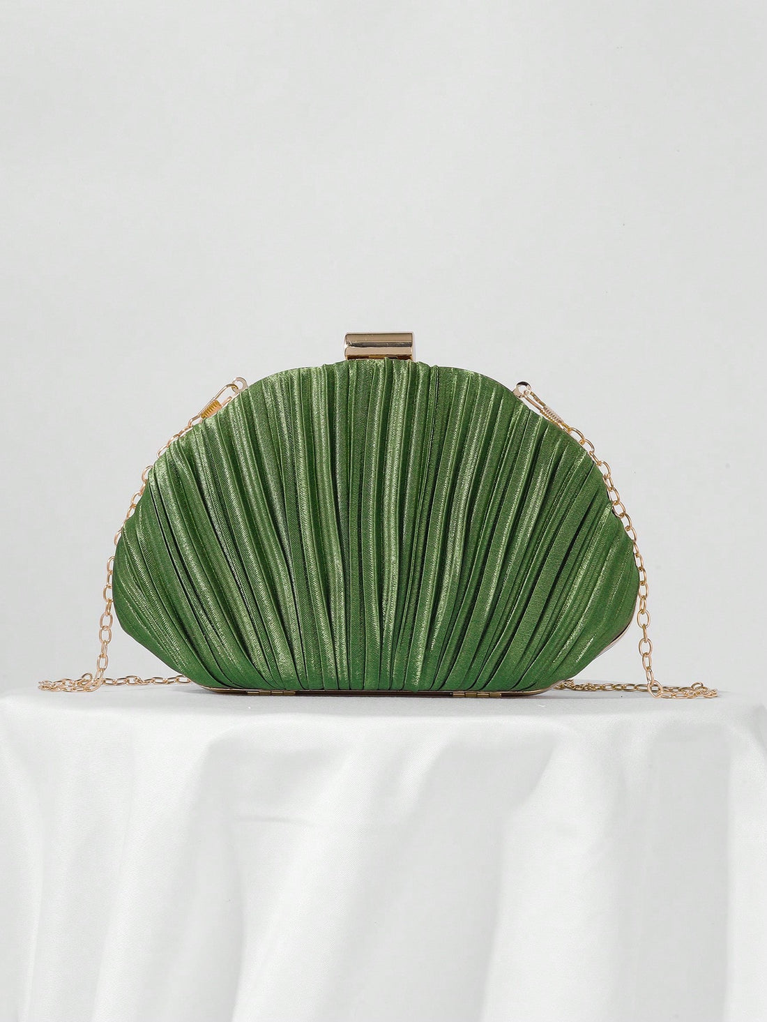 Our Elegant Pleated Satin Evening Clutch is the perfect accessory for prom and formal events. Made with high-quality satin and featuring a chic pleated design, this clutch exudes elegance and sophistication. The included chain strap allows for easy hands-free carrying, making it both stylish and functional. Enhance your outfit with this must-have accessory.