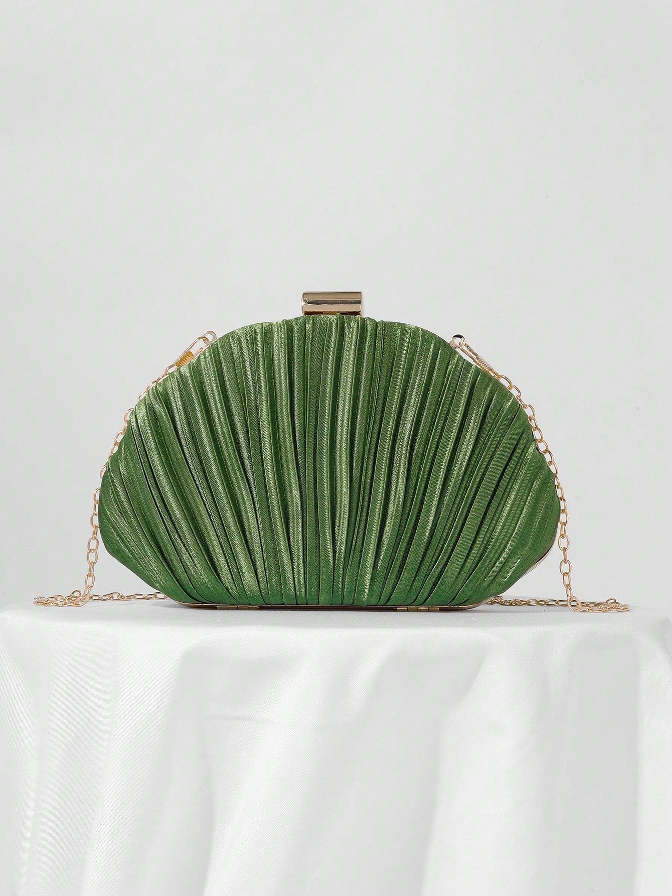 Our Elegant Pleated Satin Evening Clutch is the perfect accessory for prom and formal events. Made with high-quality satin and featuring a chic pleated design, this clutch exudes elegance and sophistication. The included chain strap allows for easy hands-free carrying, making it both stylish and functional. Enhance your outfit with this must-have accessory.