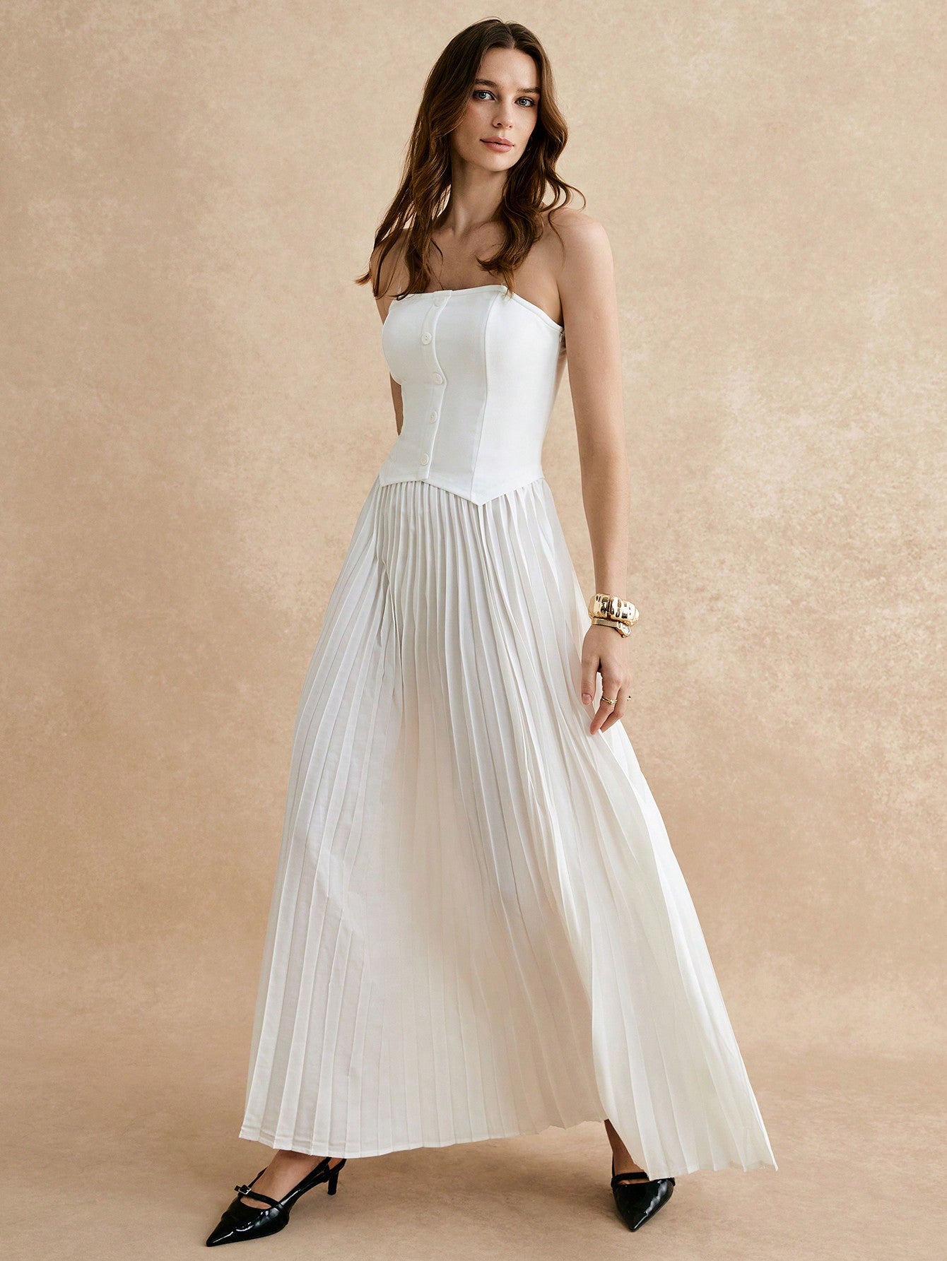 Introducing our Elegant Pleated White Tube Dress, complete with decorative buttons and detachable shoulder straps for added versatility. Perfect for any occasion, this dress exudes elegance and style. Plus, it's effortlessly chic and sure to turn heads. Upgrade your wardrobe with this stunning piece!