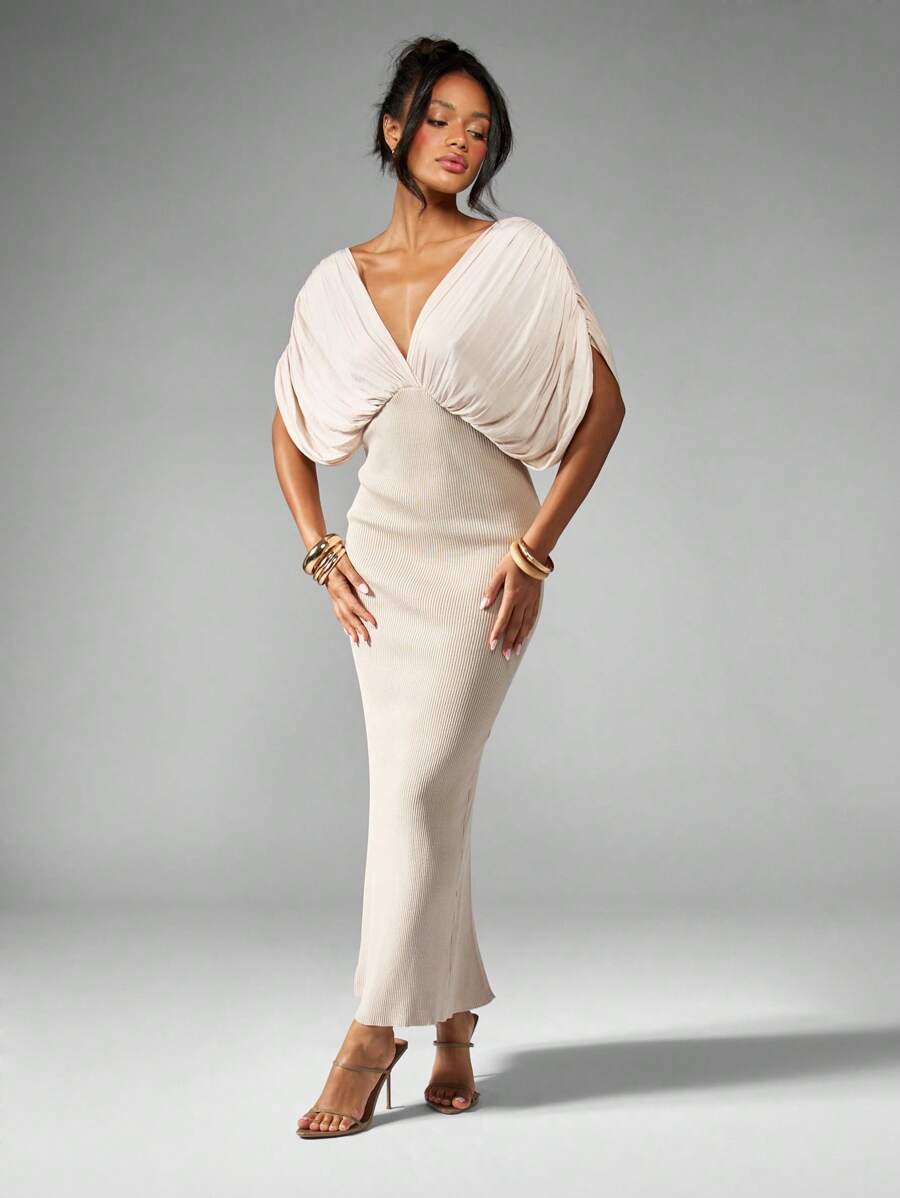 Step into the spotlight with this Elegant Plunging V-Neck Maxi Dress, designed to turn heads at any evening affair. Featuring flowing dolman sleeves that add a touch of drama and a side slit that lets you move with confidence and flair, this dress combines comfort with irresistible style. Perfect for dancing the night away or making a grand entrance, it’s your go-to for unforgettable nights out.