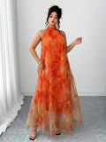 Front view of plus size orange floral mesh halter maxi dress with inner slip