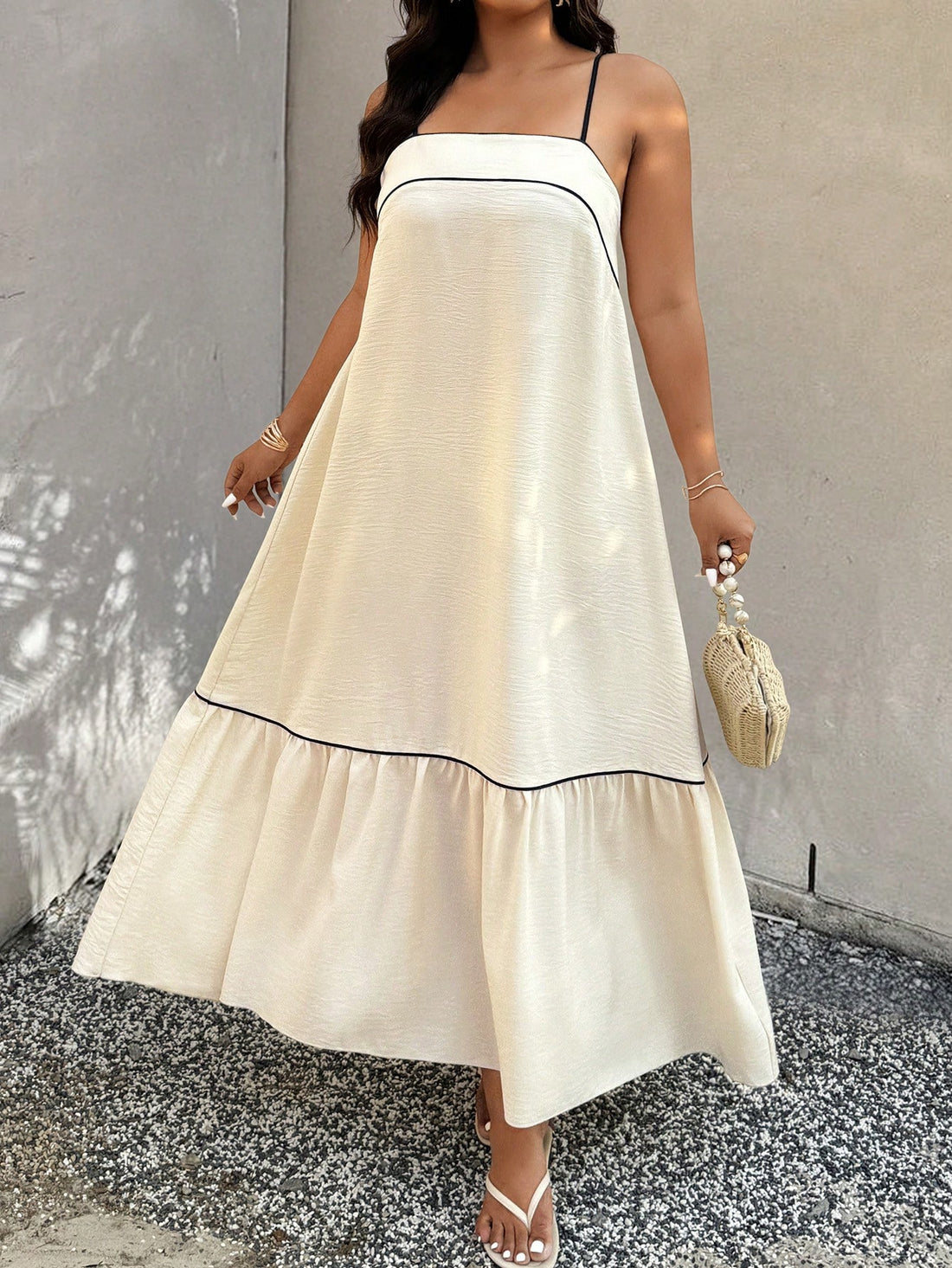 Twirl into summer with this flirty plus-size camisole dress! The playful ruffle hem adds a touch of movement to your strut, while the elegant silhouette flatters your curves in all the right places. Perfect for beach days, garden parties, or anywhere your warm-weather adventures take you. Confidence never looked so carefree!