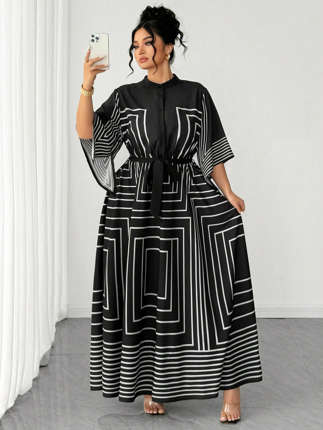 Stripes never looked so chic! This plus-size A-line dress combines timeless geometric black and white patterns with a crisp collared neckline for an effortlessly polished look. The flattering A-line silhouette skims beautifully over curves while the classic stripe design adds visual interest and movement. Perfect for dressing up or down, this versatile piece transitions seamlessly from office to weekend brunch. Comfortable, stylish, and undeniably fabulous—because looking good should always feel this easy.