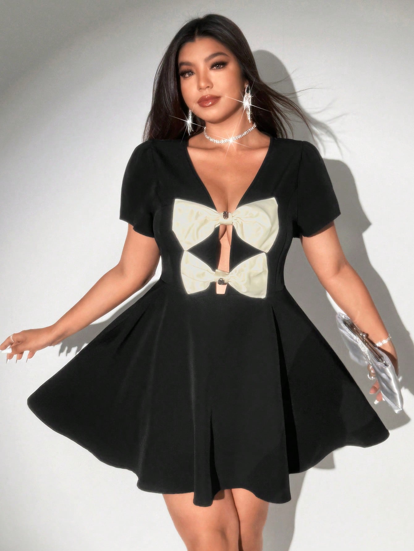 Step out in style with this playful plus size A-line mini dress, featuring a flattering deep V-neck and a charming bow detail. Its flirty silhouette enhances your curves while keeping comfort in mind, perfect for turning heads at any occasion. Embrace elegance with a fun twist!