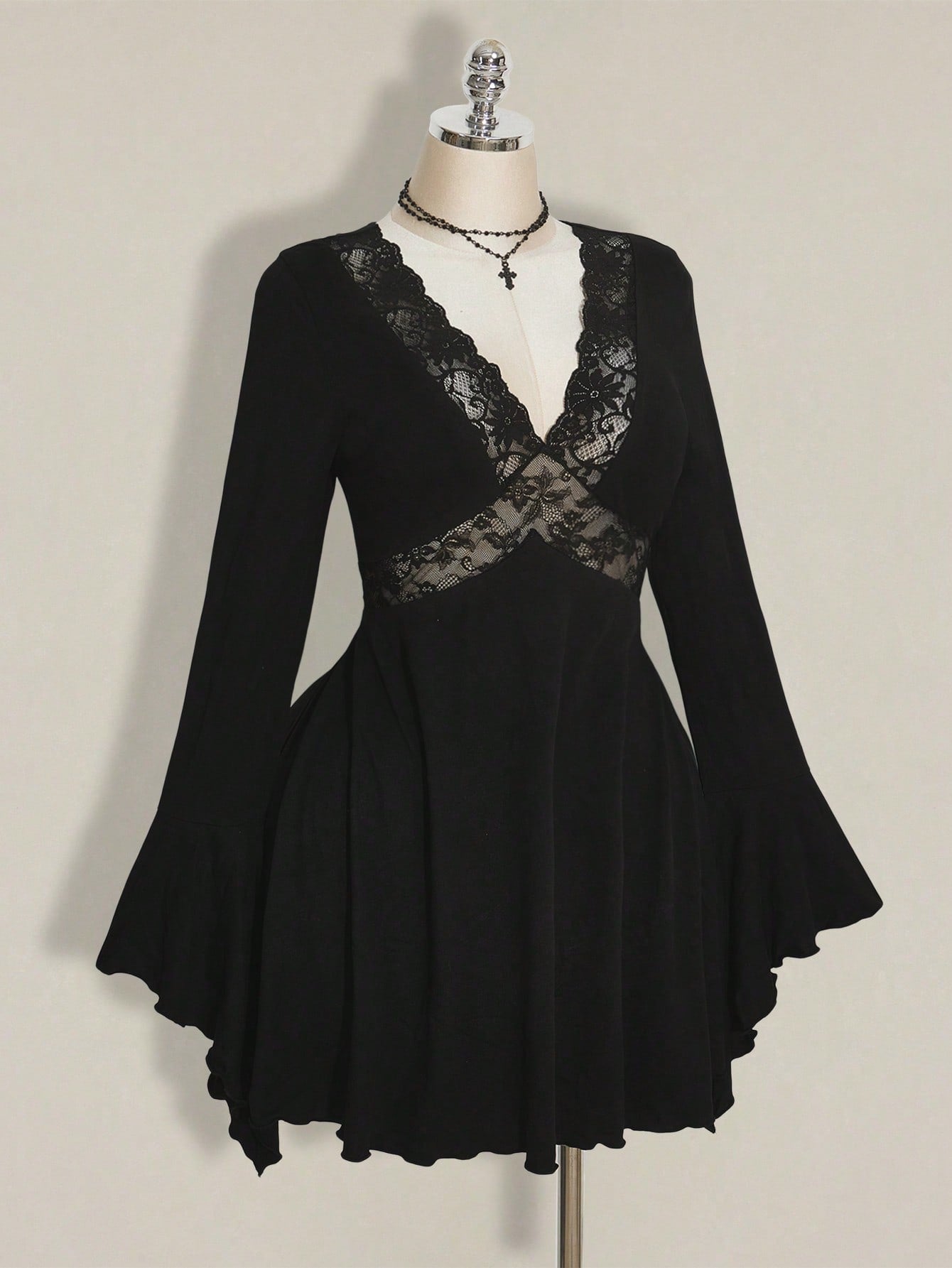 Make a statement this season in a dress that's equal parts sophisticated and fun. This elegant plus-size number features a flattering V-neckline and romantic flared sleeves adorned with delicate lace trim that catches the light beautifully. The classic black silhouette works overtime—dress it up for holiday parties or down for autumn gatherings. Designed to celebrate curves with confidence, it's the versatile piece your wardrobe has been waiting for. Perfect for anyone who refuses to compromise on style or 