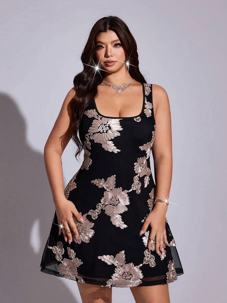Front view of black plus size mini dress with 3D floral appliqué and sheer mesh hem
