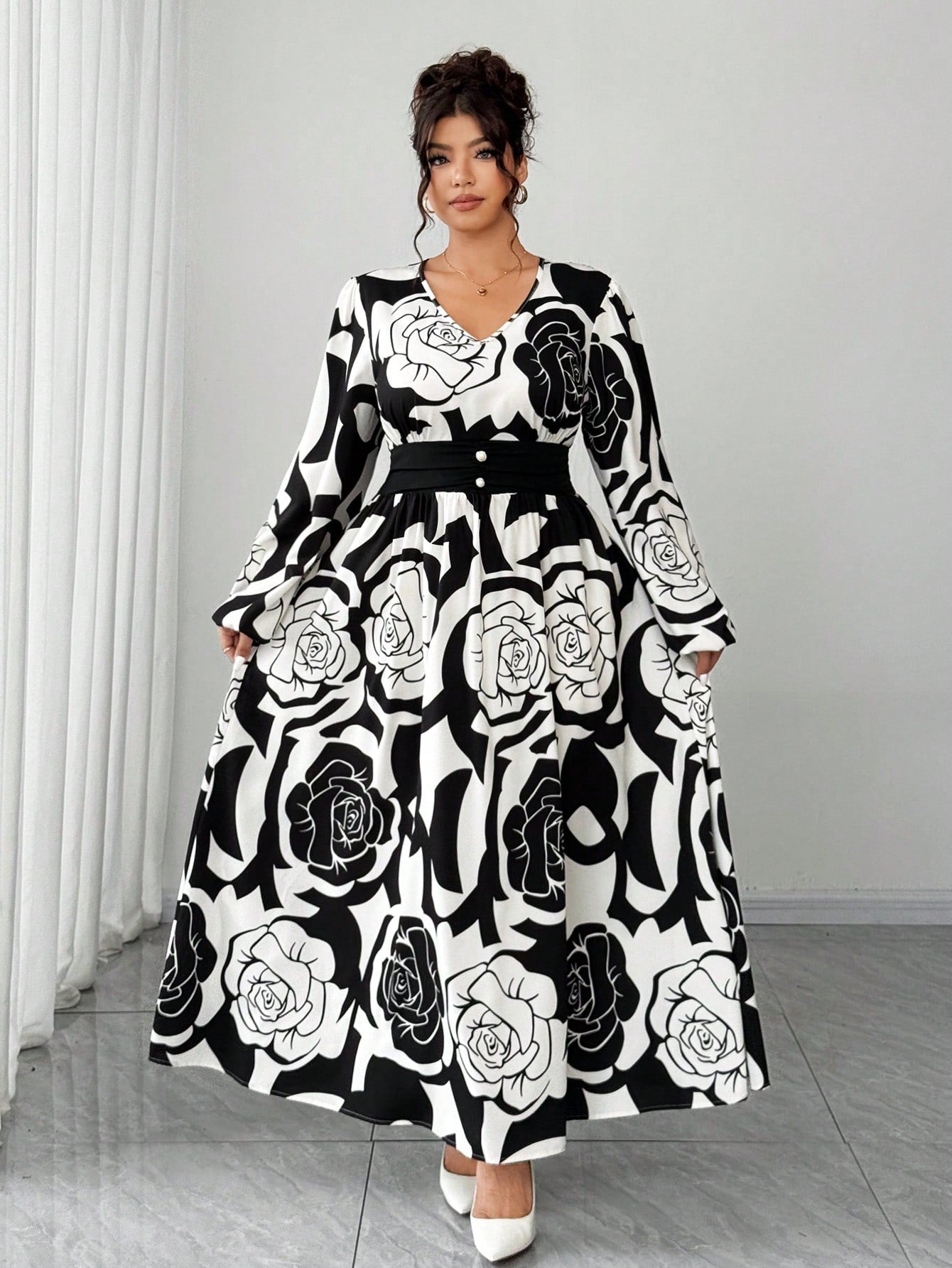 Bloom into elegance with this stunning plus-size dress that's equal parts romantic and refined. The classic black and white rose print brings timeless charm, while the long sleeves and cinched waist create a flattering silhouette that celebrates your curves. Perfect for date nights, special occasions, or whenever you want to feel absolutely fabulous. This dress proves that style has no size limit—slip it on and let your confidence blossom.