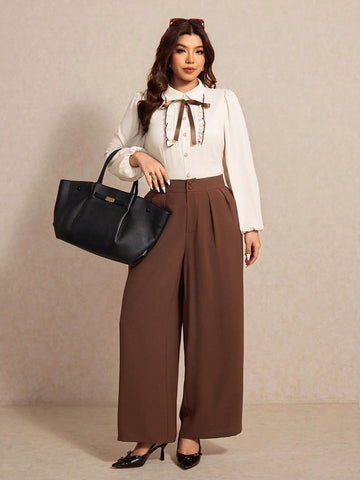 Elevate your wardrobe with this fabulous two-piece set designed for the modern woman who loves to make a statement. The long-sleeve shirt features charming bow details that add a touch of sophistication, while the flowing wide-leg pants offer comfort without compromising style. Perfect for dressing up or down, this ensemble celebrates your curves with flattering silhouettes that move with you. Whether you're heading to brunch, the office, or a night out, you'll feel confident and chic in this versatile set 