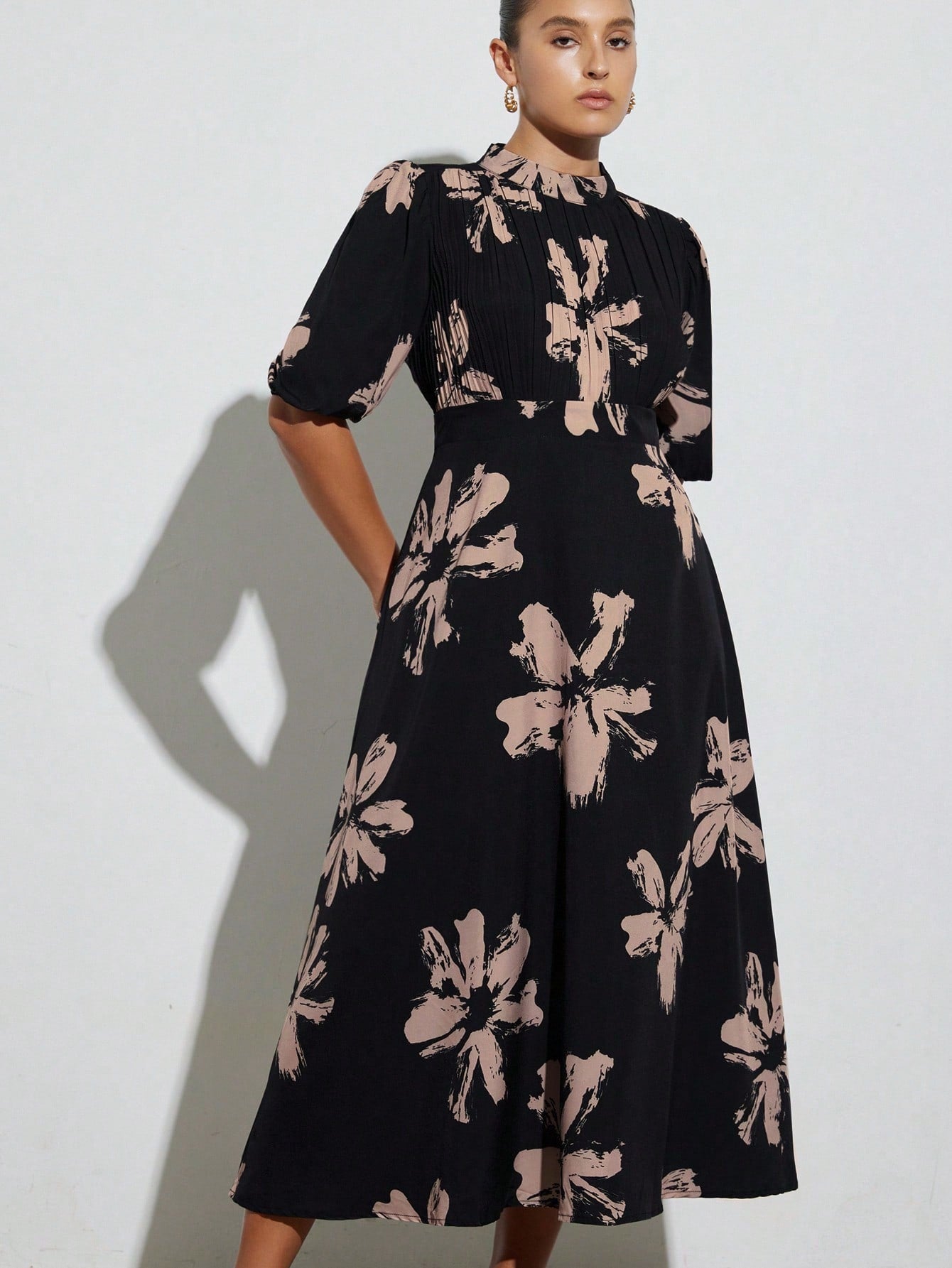 Step out in style with this Elegant Plus Size Brush Print Long Dress. Featuring a high neck and delicate pleated details, it combines comfort with a touch of sophistication. The flowing brush print adds a playful flair, making it perfect for any occasion where you want to feel fabulous and confident.