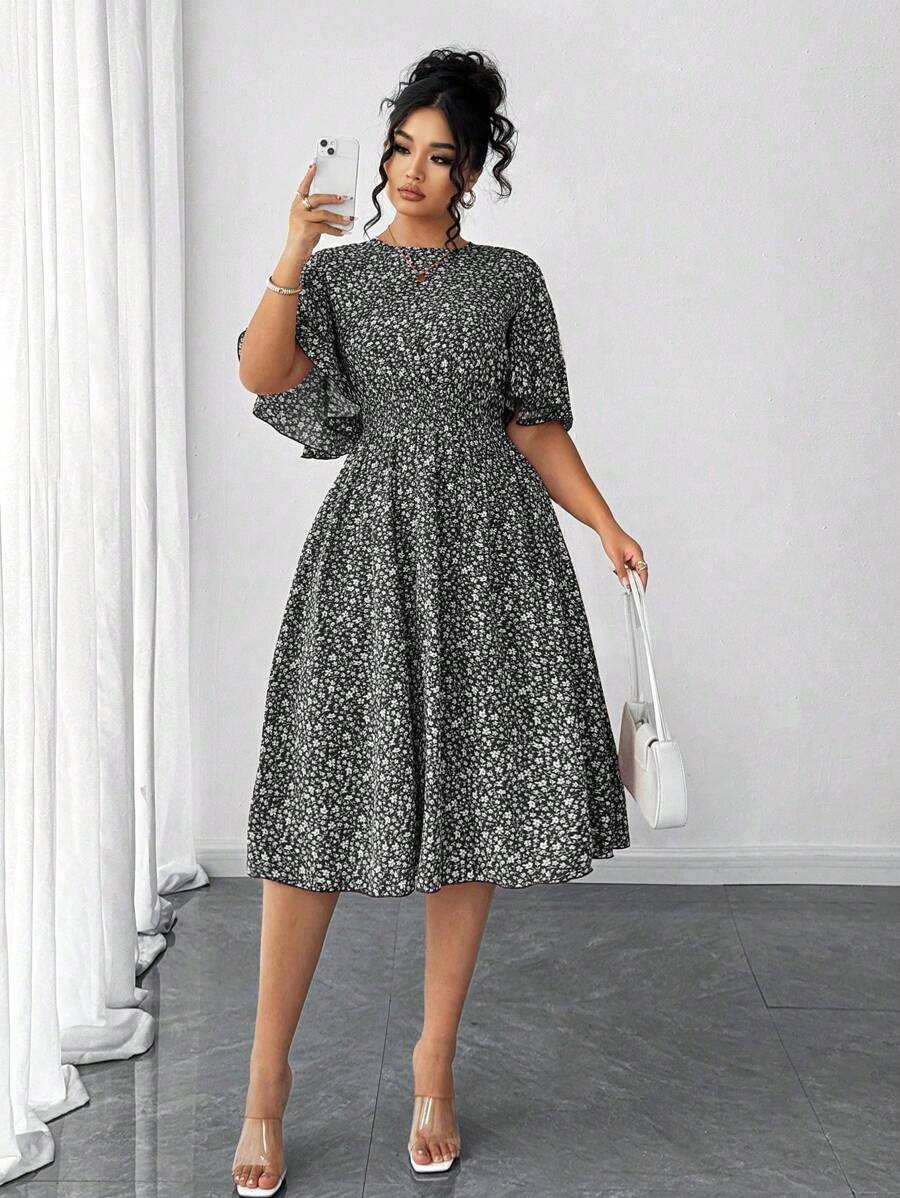 Twirl into elegance with this charming plus-size midi dress! Featuring a delicate ditsy floral print that dances across the fabric, this A-line silhouette flatters every curve while the cinched waist creates a gorgeous defined shape. Playful ruffle sleeves add a touch of whimsy and movement, making this dress perfect for brunch dates, garden parties, or any occasion calling for effortless style. The midi length offers sophisticated coverage without sacrificing fun. Slip it on and let your confidence bloom!