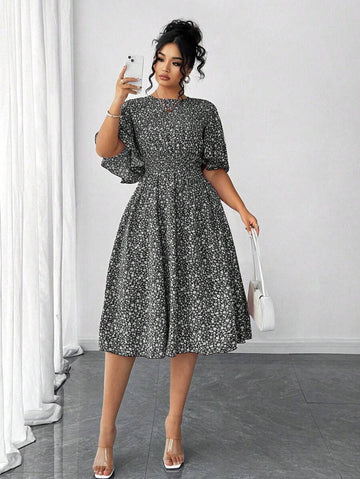 Twirl into elegance with this charming plus-size midi dress! Featuring a delicate ditsy floral print that dances across the fabric, this A-line silhouette flatters every curve while the cinched waist creates a gorgeous defined shape. Playful ruffle sleeves add a touch of whimsy and movement, making this dress perfect for brunch dates, garden parties, or any occasion calling for effortless style. The midi length offers sophisticated coverage without sacrificing fun. Slip it on and let your confidence bloom!