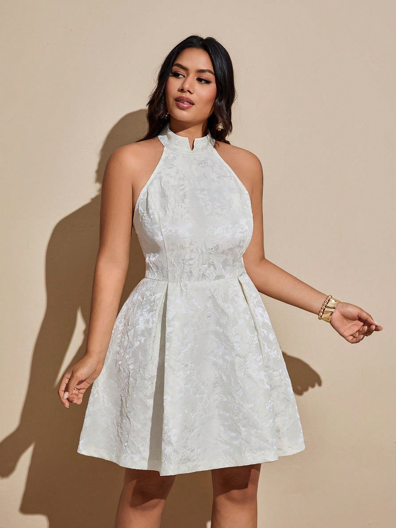 Turn heads with this Elegant Plus Size Floral Jacquard Halter Neck Sleeveless Dress. Its vibrant floral jacquard fabric adds a touch of whimsy, while the halter neck design highlights your shoulders with playful charm. Perfect for any occasion, this dress combines comfort and style effortlessly, making you feel confident and fabulous all day long.