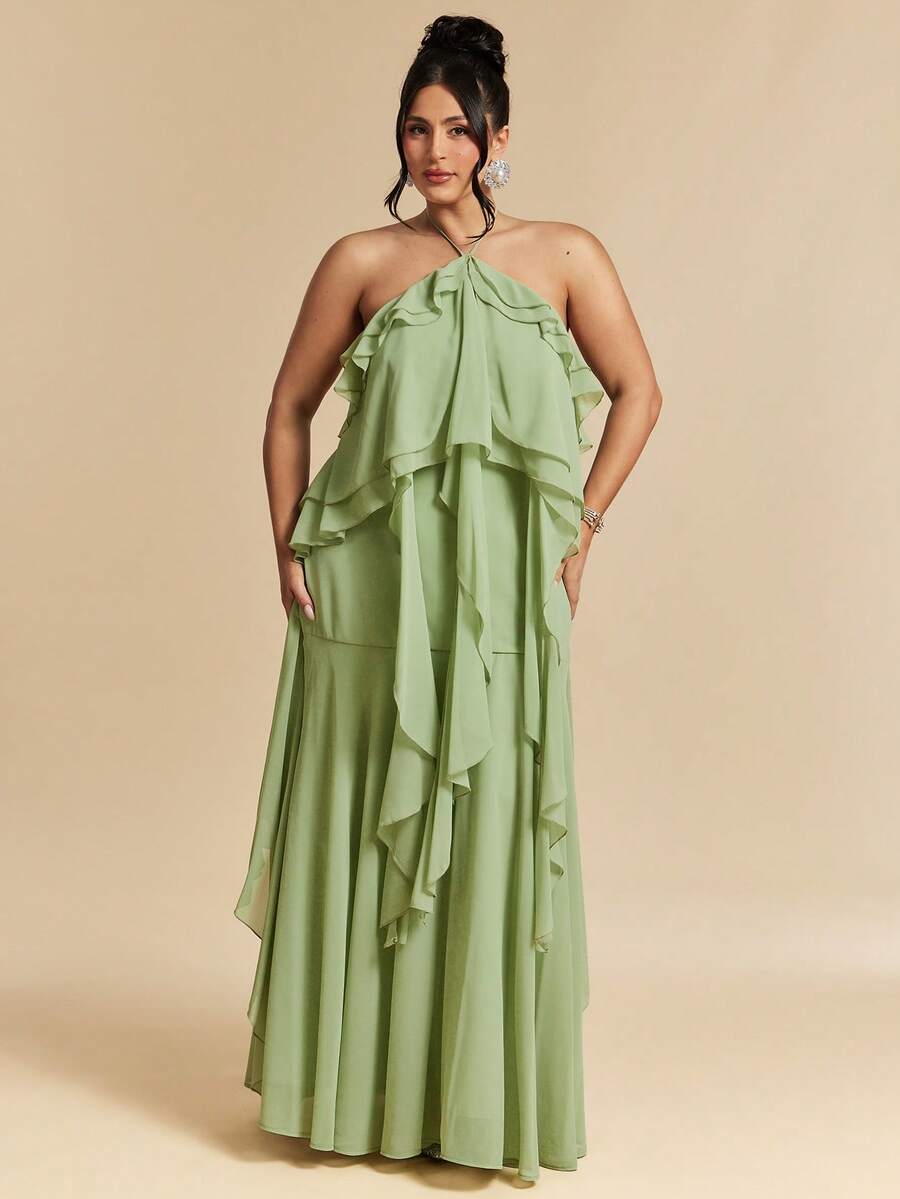 Elevate your wardrobe with this stunning plus-size green halter neck dress, designed for those who embrace elegance and comfort. The flowing maxi silhouette features delicate ruffled details and a flattering tie-back design that creates a graceful, backless look perfect for beach getaways and special celebrations. Crafted from quality woven polyester with a lined interior, this dress offers a polished appearance while maintaining breathability. 