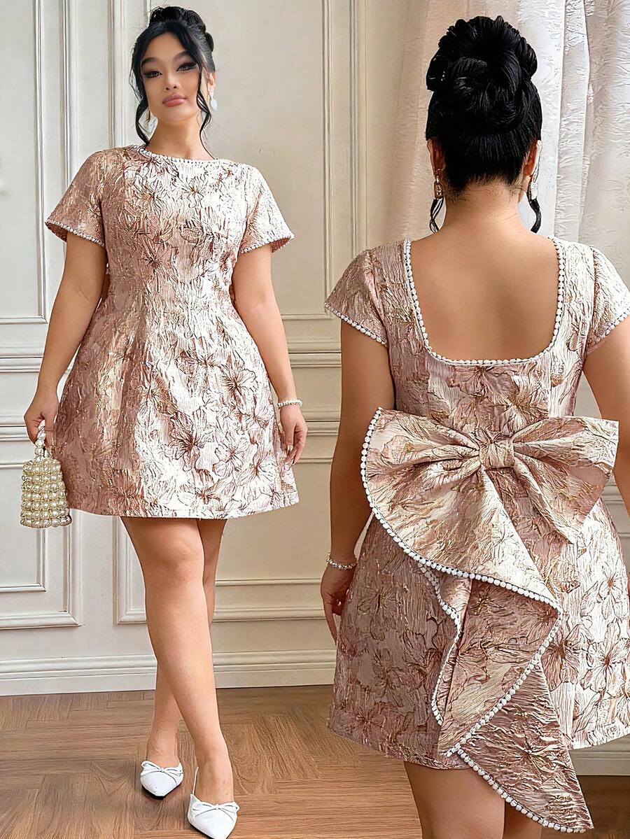 Elevate your special occasion wardrobe with this stunning plus-size jacquard dress. Featuring intricate jacquard fabric paired with delicate lace patchwork details and an elegant bow accent, this dress combines sophistication with modern flair. The thoughtful design flatters curves while offering comfort for all-day wear. Perfect for weddings, parties, and formal events, this piece makes a confident statement. Available in plus sizes to ensure the perfect fit for every body type.