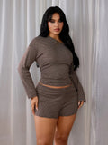 Front view of a plus-size brown-and-cream striped knit crop top and matching mini shorts set