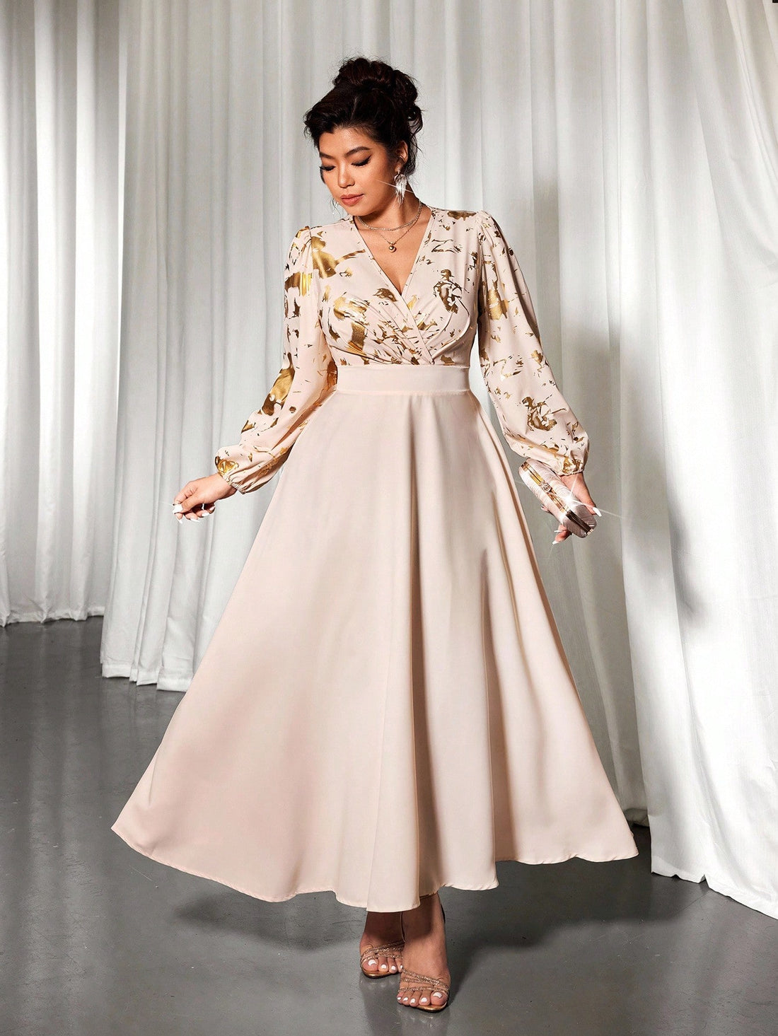 Step out in style with this Elegant Plus Size Long Sleeve Dress, featuring a stunning gold foil print that adds a touch of sparkle to your look. The cinched waist beautifully defines your silhouette while keeping comfort in mind. Perfect for turning heads at any event, this dress blends elegance with fun flair effortlessly.