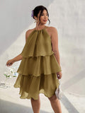 Front view of olive tiered halter dress with ruffled A-line skirt