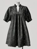 Step into timeless style with this charming plus-size plaid dress that brings vintage flair to your modern wardrobe. The flattering V-neckline pairs beautifully with delicate ruffle trim detailing, creating an effortlessly elegant silhouette. Perfect for anyone who loves retro-inspired fashion with a contemporary twist, this dress transitions seamlessly from casual outings to special occasions. Embrace your curves with confidence in a piece designed to celebrate your unique style and personality.