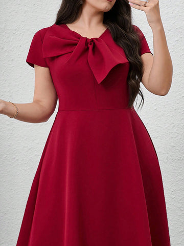 Step out in style with this Elegant Plus Size Short Sleeve Dress, featuring a charming bow detail that adds a flirty twist to your look. Its solid color design keeps things classic, while the flattering cut ensures comfort and confidence all day long. Perfect for brunches, parties, or just because you deserve to feel fabulous!