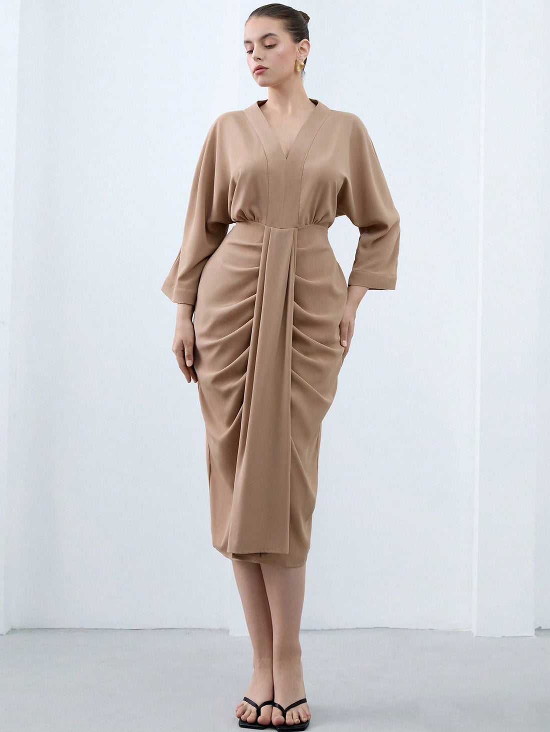 Turn heads effortlessly in this Elegant Plus Size V-Neck Midi Bodycon Dress. Featuring a flattering V-neckline, playful ruffle hem, and chic 3/4 sleeves, it hugs your curves in all the right places. Perfect for any occasion where you want to feel confident and fabulous with a touch of fun!