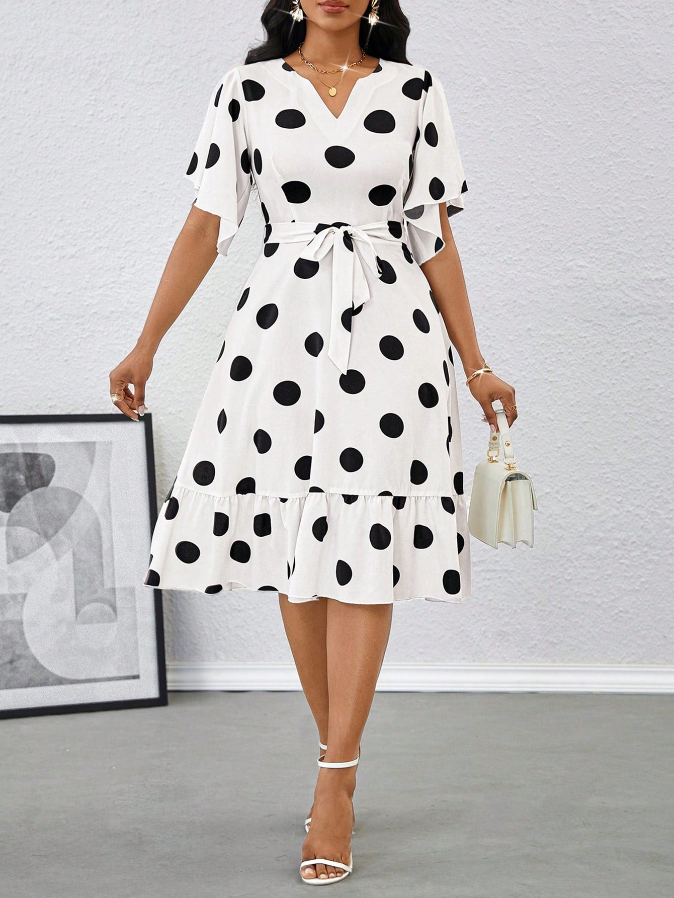 Unleash your inner fashionista with this elegant polka dot midi dress! This dress features playful ruffle sleeves and a self-tie belt for a flattering and stylish look. Perfect for summer, this dress will have you looking and feeling stylish and confident. Go ahead, add it to your wardrobe! (Fashion-forward, stylish, flattering)