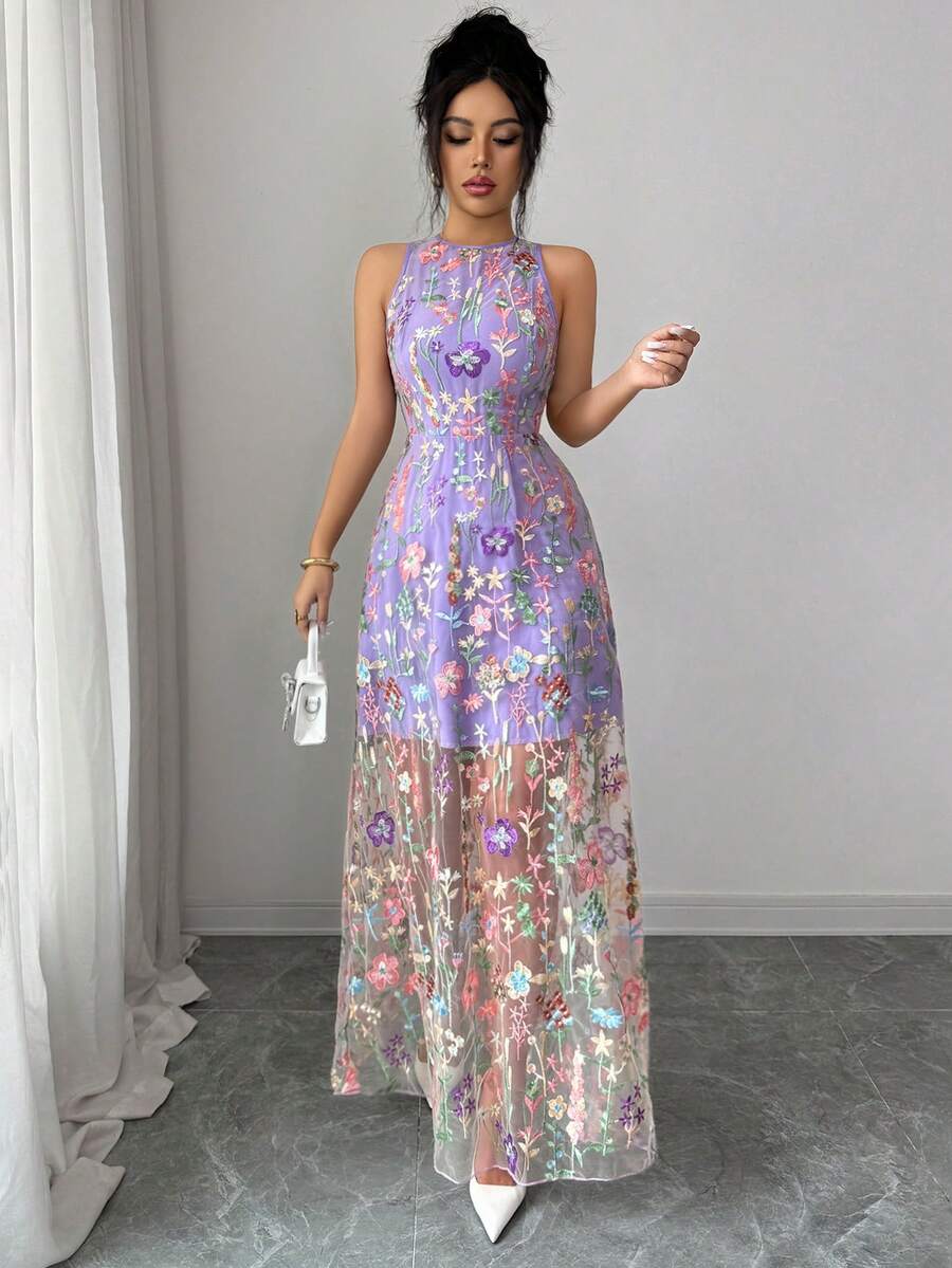 This Elegant Purple Embroidered Mesh Dress features a delicate botanical overlay and a flowing silhouette to ensure every movement feels graceful and light.