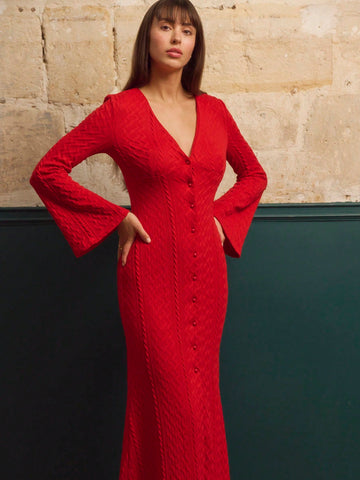 Make a statement this season in our stunning red knitted maxi dress! Featuring a flattering deep V-neckline, romantic flare sleeves, and a charming button-front closure, this dress effortlessly transitions from holiday parties to New Year's Eve celebrations. The luxurious knit fabric drapes beautifully while keeping you cozy and comfortable. Whether you're dancing the night away or enjoying festive gatherings, this showstopper delivers elegance with a touch of playful flair. Your go-to dress for all your se