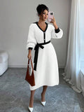 Front view of white and black belted polo collar knit midi dress with bishop sleeves and button front