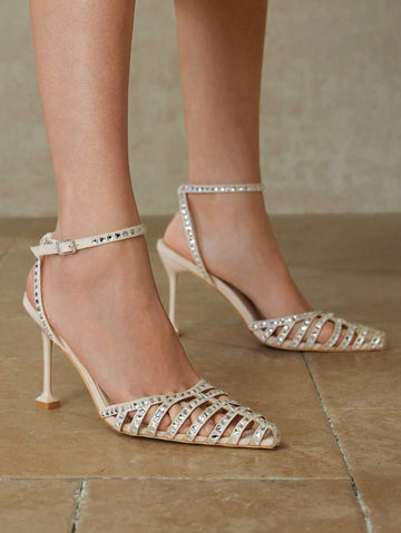 Step out in style with these elegant high heels featuring a sparkling rhinestone embellishment and a chic hollow pointed toe design. Perfect for adding a touch of glamour to any outfit, these heels combine sophistication with a playful edge to keep you shining all night long.