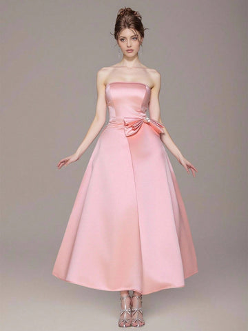 Step into the spotlight in this show-stopping ball gown that's practically begging for a grand entrance! Adorned with shimmering rhinestones and a fabulous bow detail at the bandeau neckline, this dress transforms you into the belle of the ball. Perfect for graduations, proms, or any occasion where you want to feel absolutely magical, the luxurious silhouette flatters every figure while the glittering embellishments catch the light with every twirl. Get ready to turn heads and collect compliments all night 