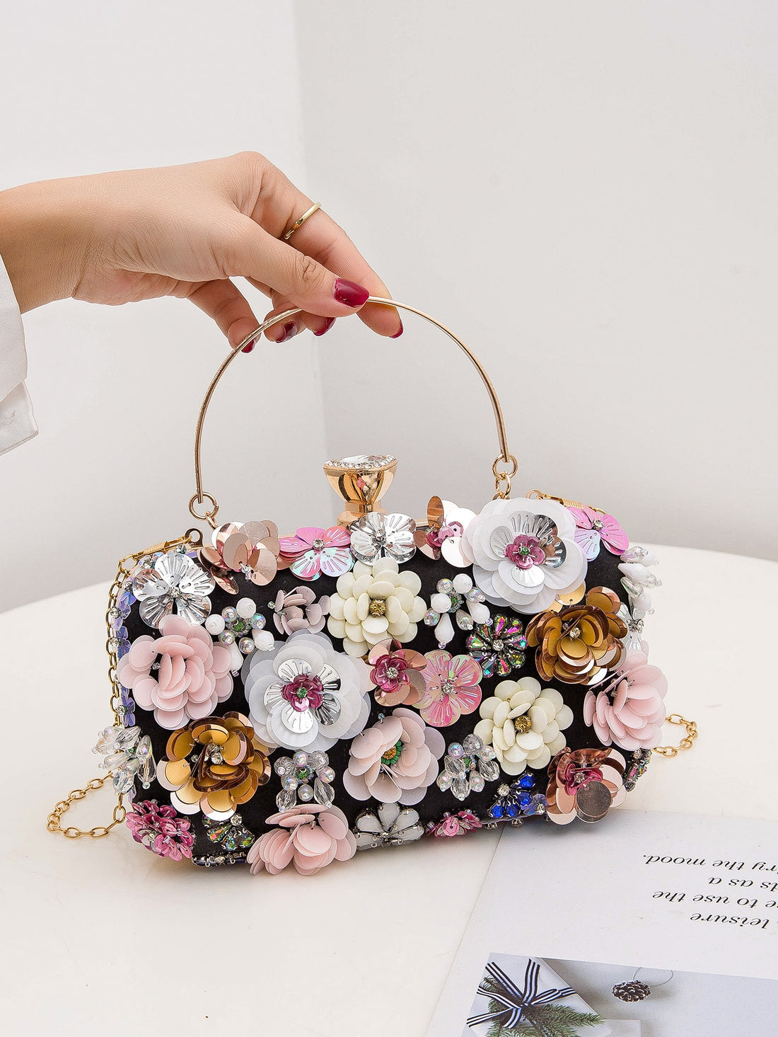 This Elegant Rhinestone Floral Clip Top Box Bag is the perfect accessory for any special occasion. With its sparkling rhinestone floral design and convenient clip top closure, it adds a touch of elegance to weddings, proms, and parties. Its compact size makes it ideal for carrying essentials without sacrificing style.