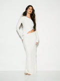 Make a statement at your next winter celebration with this chic two-piece set that's equal parts cozy and glamorous. The ribbed crop sweater top features a textured long sleeve design that hugs in all the right places, while the flowing maxi skirt adds an effortless elegance. Whether you're heading to a winter wedding or special occasion, this pairing strikes the perfect balance between comfort and sophistication. Dress it up with heels and jewelry, or keep it casual for a night out. Because looking fabulou