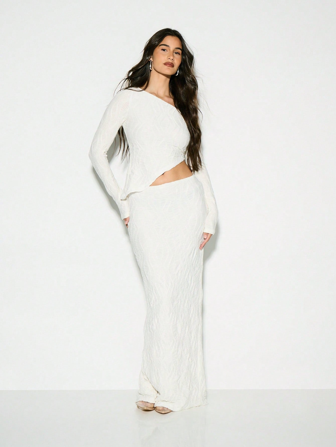 Make a statement at your next winter celebration with this chic two-piece set that's equal parts cozy and glamorous. The ribbed crop sweater top features a textured long sleeve design that hugs in all the right places, while the flowing maxi skirt adds an effortless elegance. Whether you're heading to a winter wedding or special occasion, this pairing strikes the perfect balance between comfort and sophistication. Dress it up with heels and jewelry, or keep it casual for a night out. Because looking fabulou