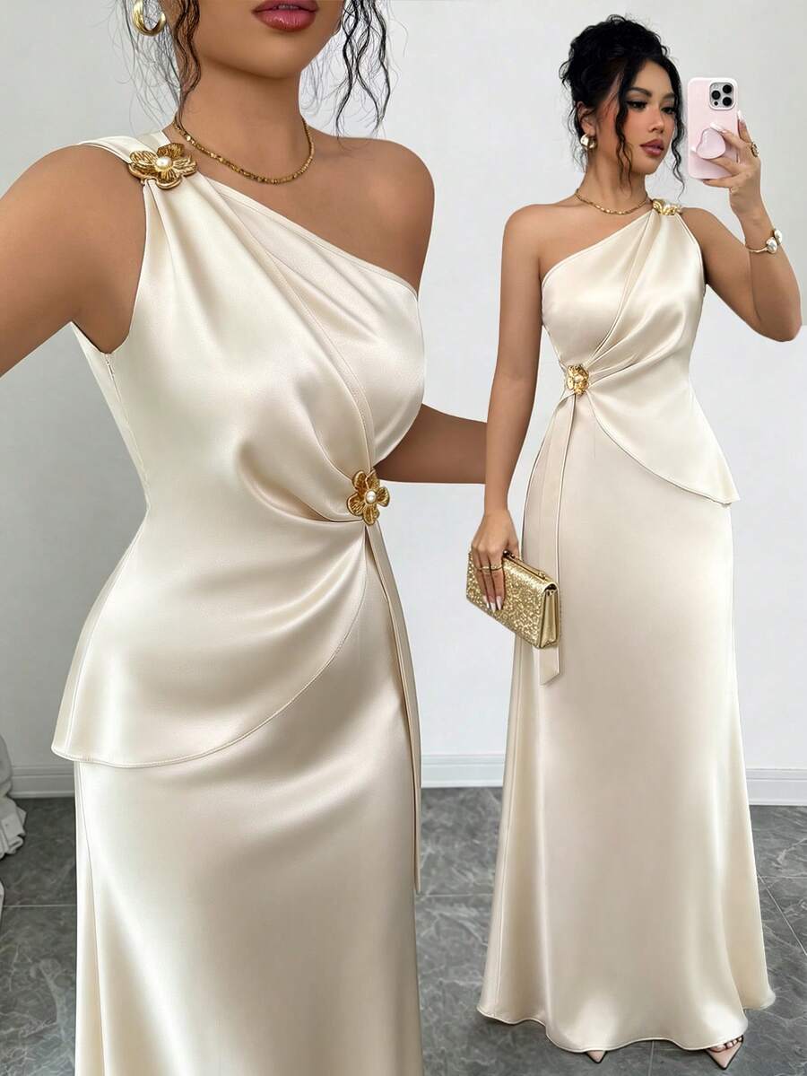Champagne satin one-shoulder maxi dress with gold floral brooches and draped peplum